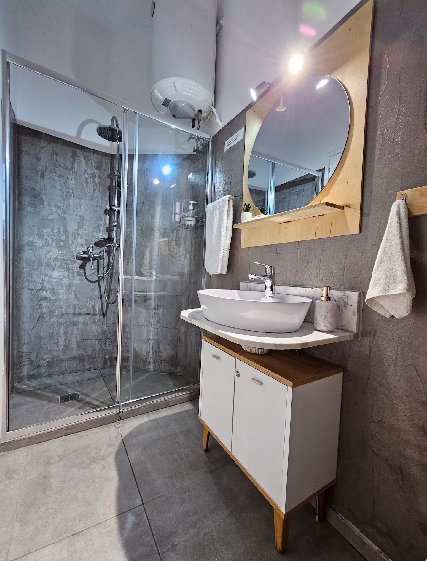 Modern bathroom with walk-in glass shower and marble-topped vanity